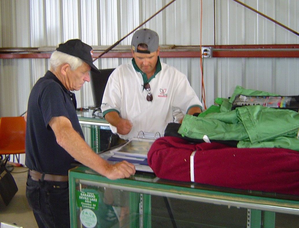 Pat talking sleds with a show goer.