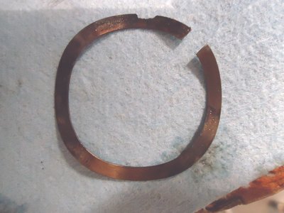 This is a wavy washer.  Note the corrosion at the 12 oclock level.  I think it is useable again. One KH guy said he'd never seen a "split" washer previously but the diagram shows it is supposed to be split.